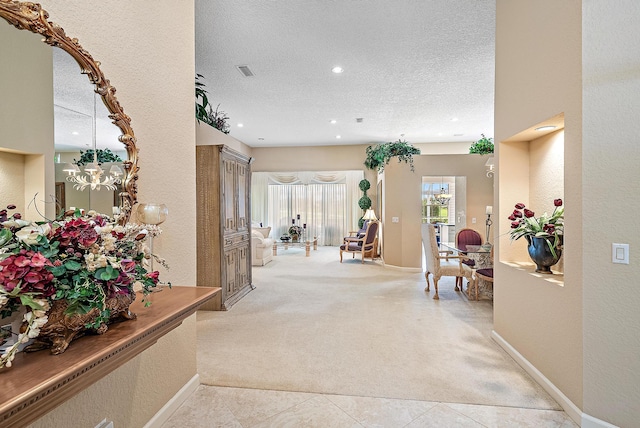 interior space with light carpet and a textured ceiling