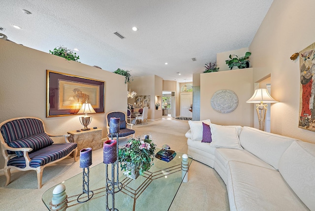 carpeted living room featuring a textured ceiling