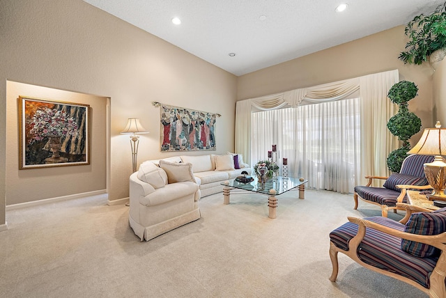 carpeted living room featuring lofted ceiling