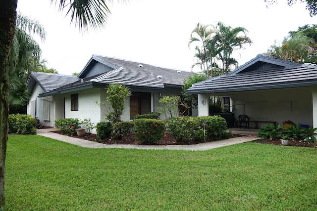 rear view of house featuring a yard