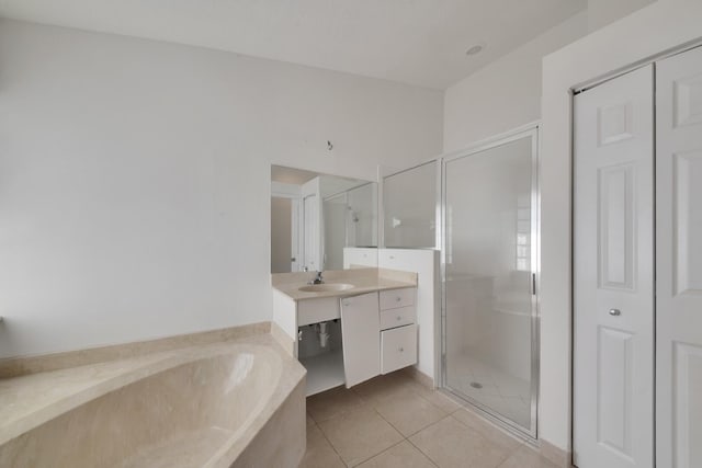 bathroom featuring tile patterned flooring, vanity, and shower with separate bathtub