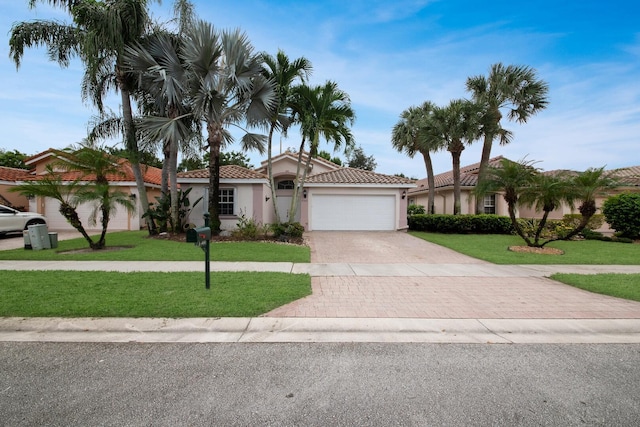 view of front of house with a garage and a front yard