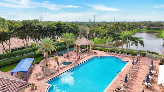 view of swimming pool featuring a gazebo, a water view, and a patio