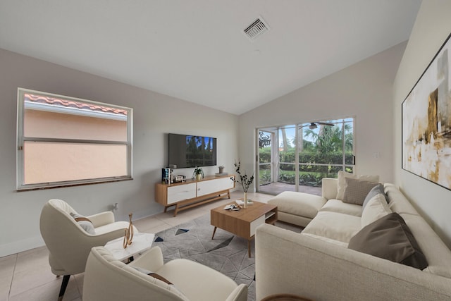 living room featuring lofted ceiling and light tile patterned flooring