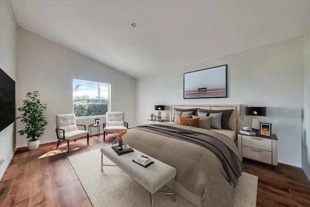 bedroom with lofted ceiling and dark hardwood / wood-style floors