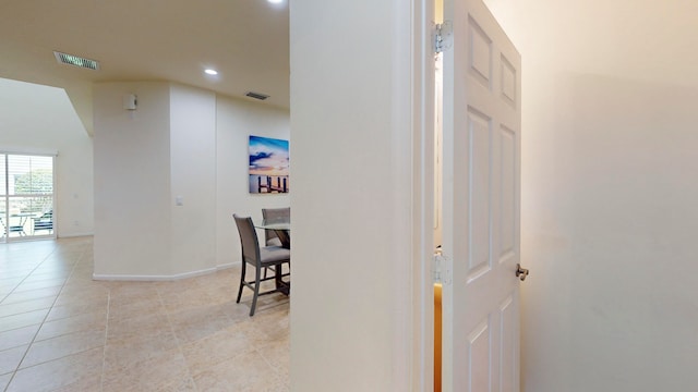 hall with light tile patterned floors