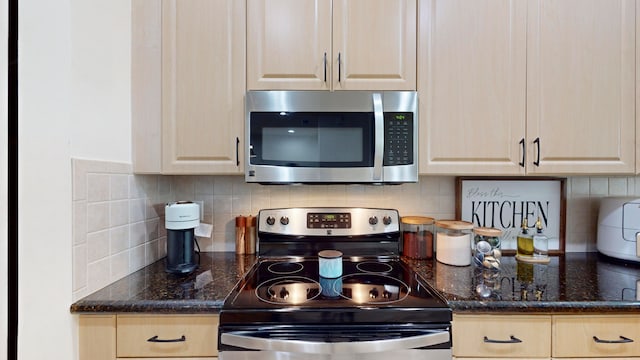 kitchen with tasteful backsplash, light brown cabinets, stainless steel appliances, and dark stone counters