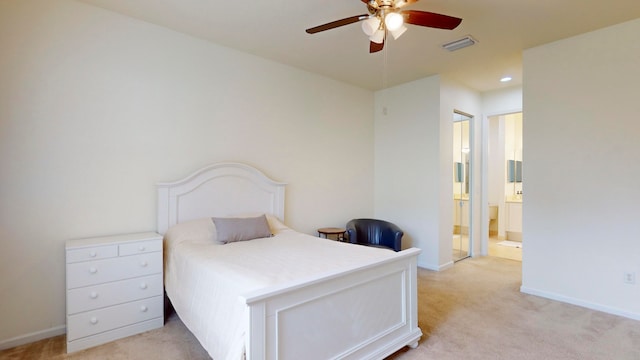 carpeted bedroom featuring connected bathroom and ceiling fan