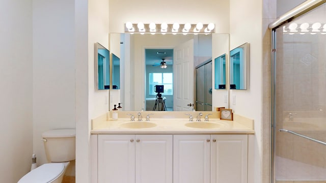 bathroom with an enclosed shower, toilet, and vanity