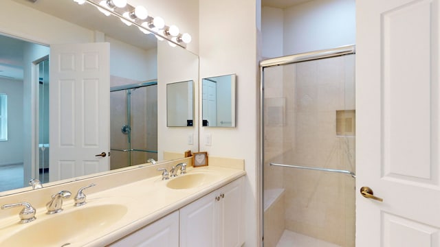 bathroom featuring vanity and a shower with shower door