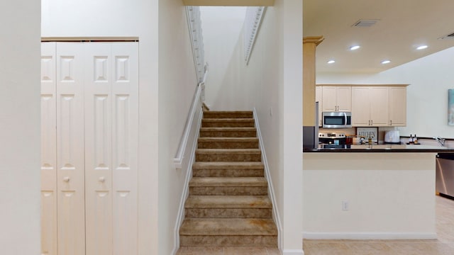 stairs featuring tile patterned flooring