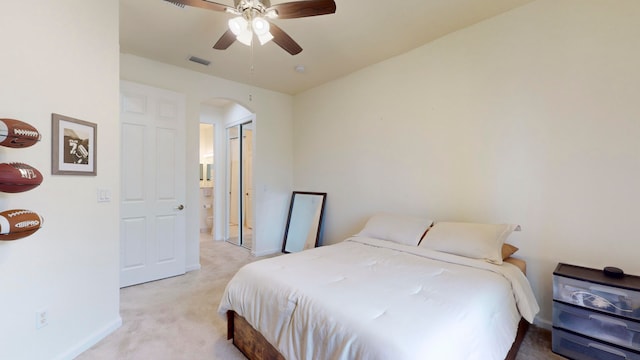 carpeted bedroom featuring ceiling fan and a closet