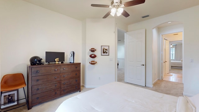 bedroom with ceiling fan and light colored carpet