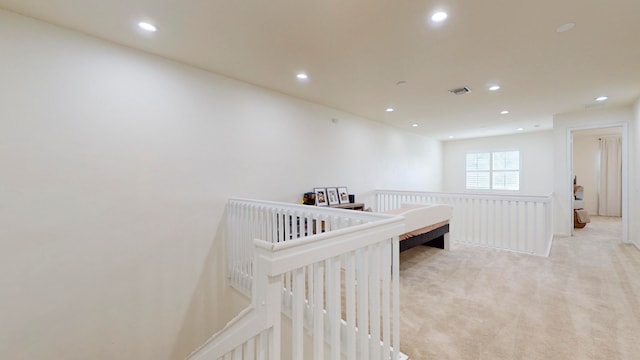 corridor with light colored carpet