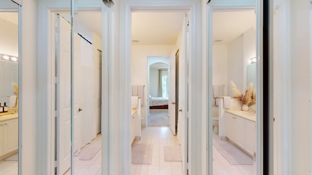 interior space with tile patterned flooring, toilet, and vanity