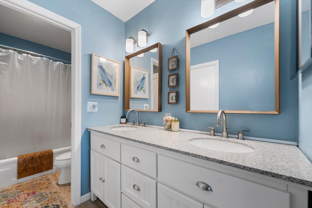 full bathroom featuring shower / bath combo, vanity, and toilet