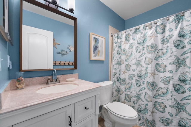 bathroom featuring vanity, toilet, and a shower with curtain