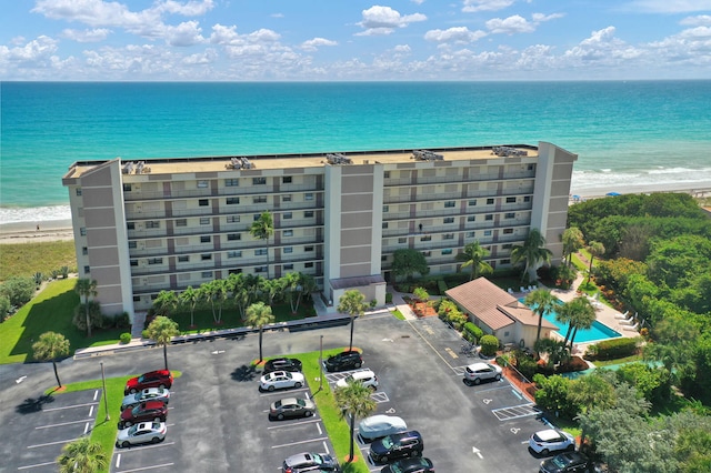 drone / aerial view featuring a water view and a view of the beach