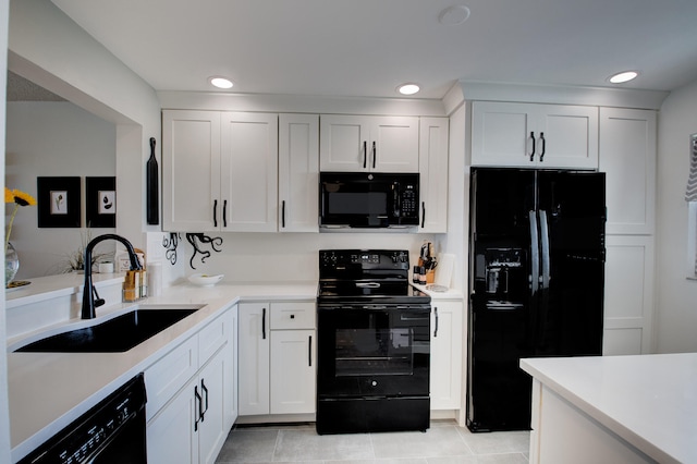 kitchen featuring white cabinets, light tile patterned flooring, sink, and black appliances