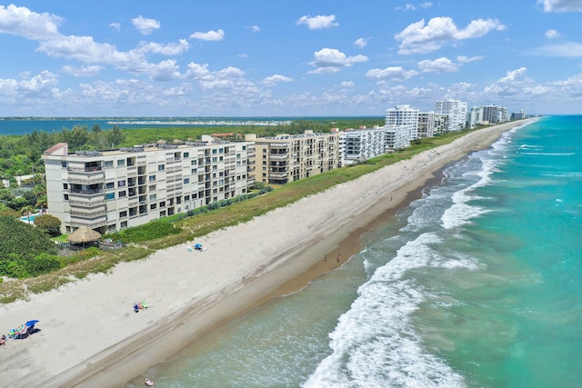 birds eye view of property with a water view and a view of the beach