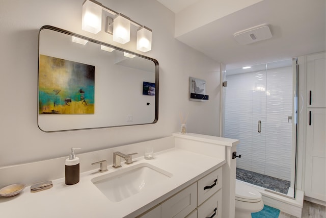 bathroom with vanity, hardwood / wood-style flooring, an enclosed shower, and toilet