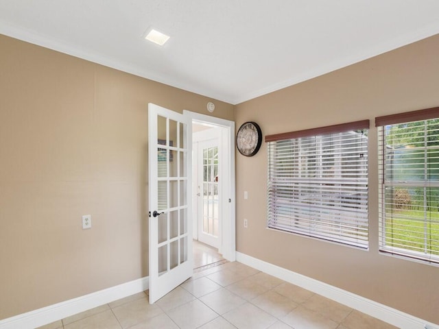 tiled entrance foyer with french doors and ornamental molding