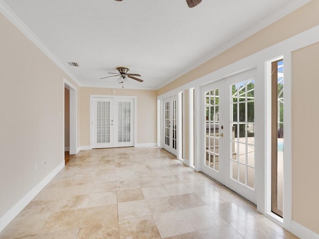 spare room featuring crown molding, ceiling fan, and french doors