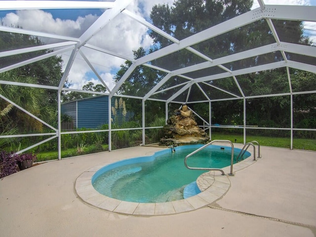 view of swimming pool with a lanai and a patio area