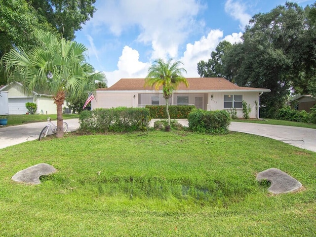 single story home with a garage and a front lawn