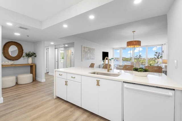 kitchen featuring dishwasher, pendant lighting, light hardwood / wood-style flooring, sink, and white cabinetry