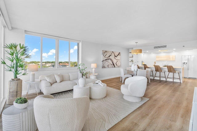 living room with light hardwood / wood-style flooring