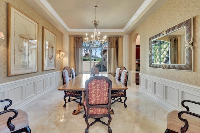 dining room featuring a tray ceiling, crown molding, and a chandelier