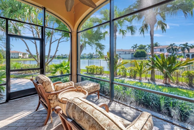 sunroom / solarium featuring a water view and a healthy amount of sunlight