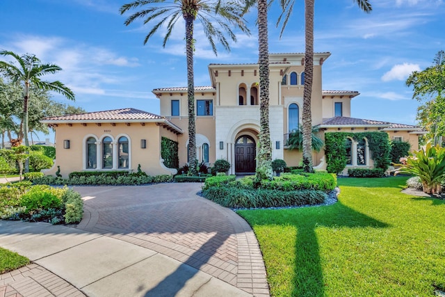 mediterranean / spanish house with a front lawn