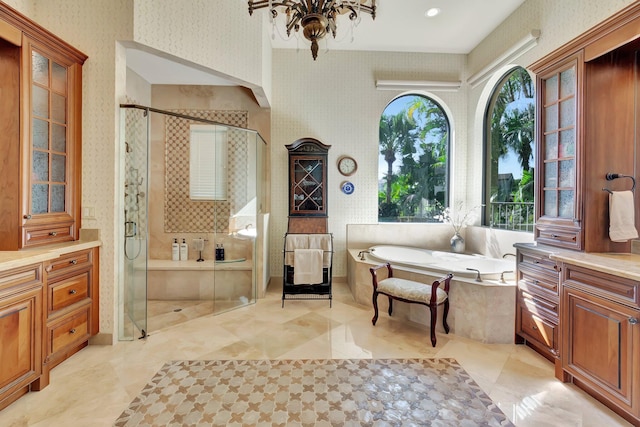 bathroom featuring independent shower and bath and vanity