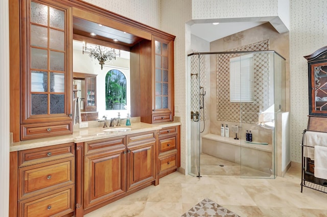 bathroom with a shower with shower door and vanity