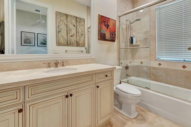 full bathroom featuring tile patterned flooring, shower / bath combination with glass door, ceiling fan, vanity, and toilet