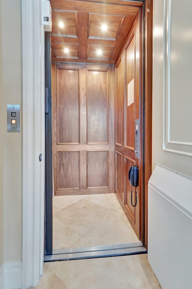 details with coffered ceiling, wooden walls, wood ceiling, and elevator