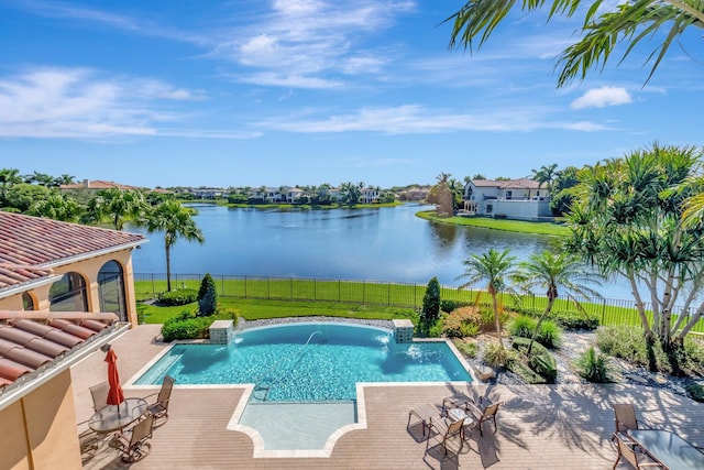 view of pool featuring a water view, a yard, pool water feature, and a patio area