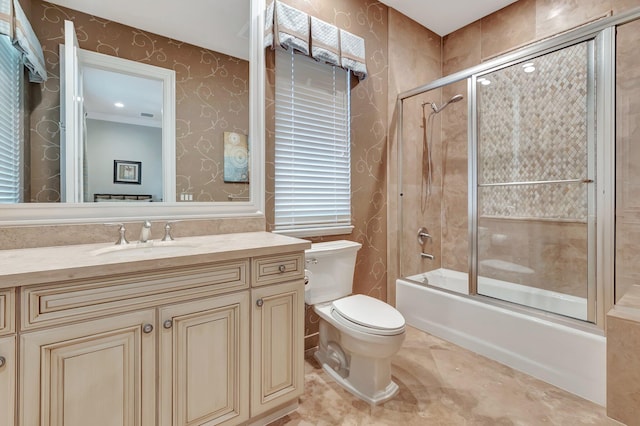 full bathroom with shower / bath combination with glass door, toilet, and vanity