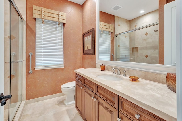 bathroom with vanity, toilet, and a shower with shower door