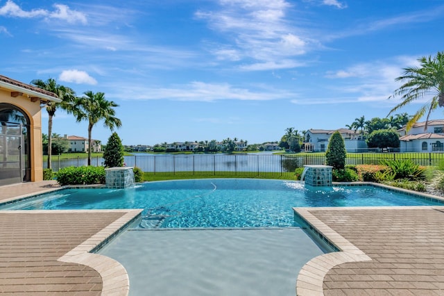 view of swimming pool with pool water feature, a water view, and a patio area