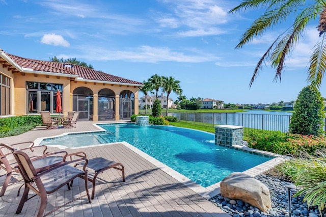 view of swimming pool with a patio, a sunroom, a water view, and pool water feature