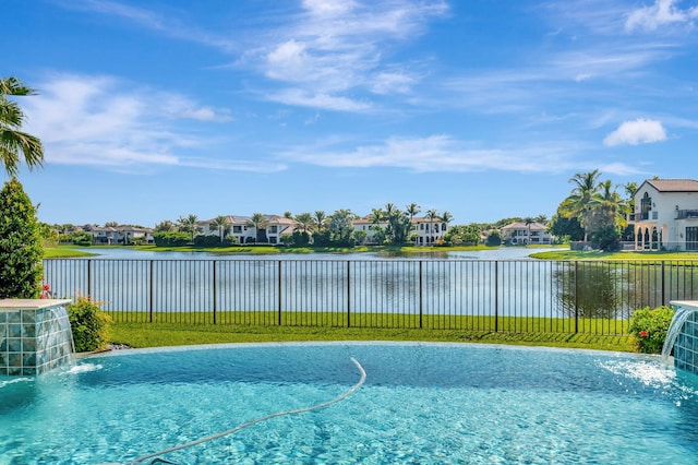 view of pool featuring pool water feature and a water view