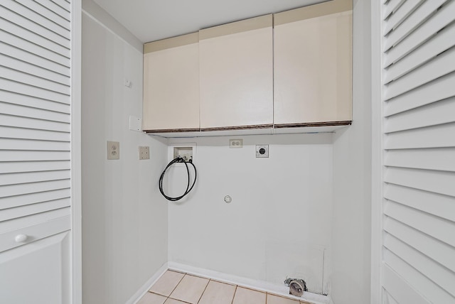 laundry area featuring cabinets, gas dryer hookup, hookup for an electric dryer, washer hookup, and light tile patterned flooring