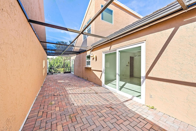 view of patio featuring a lanai