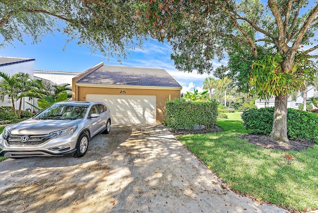 view of front of house featuring a garage and a front lawn