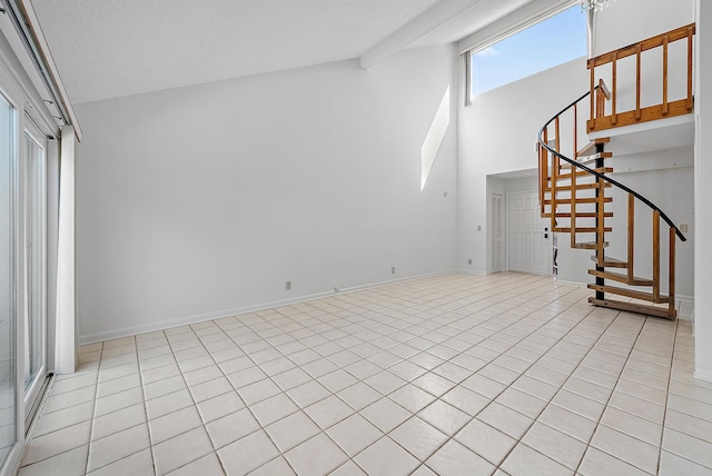 unfurnished living room with a textured ceiling, high vaulted ceiling, beam ceiling, and light tile patterned flooring