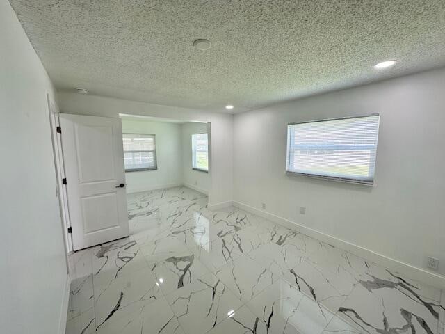 empty room with a textured ceiling