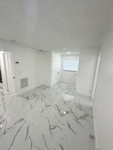 spare room featuring a textured ceiling